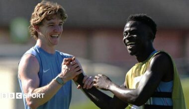 Anthony Gordon and Bukayo Saka smile during training for England at the World Cup