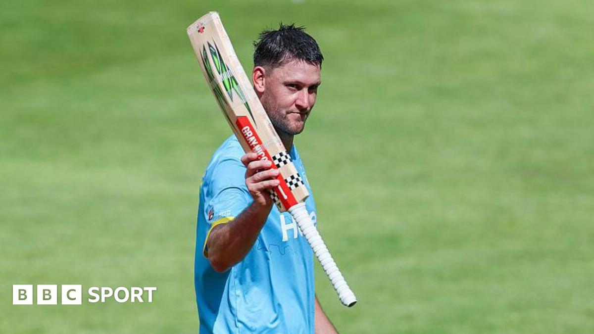 Warwickshire Bears all-rounder Beau Webster raises his bat to the crowd during the match with Northamptonshire