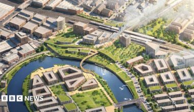 A CGI of the proposed masterplan. The station is on the top right of the image, and then there are office blocks and apartment buildings centred around a river.