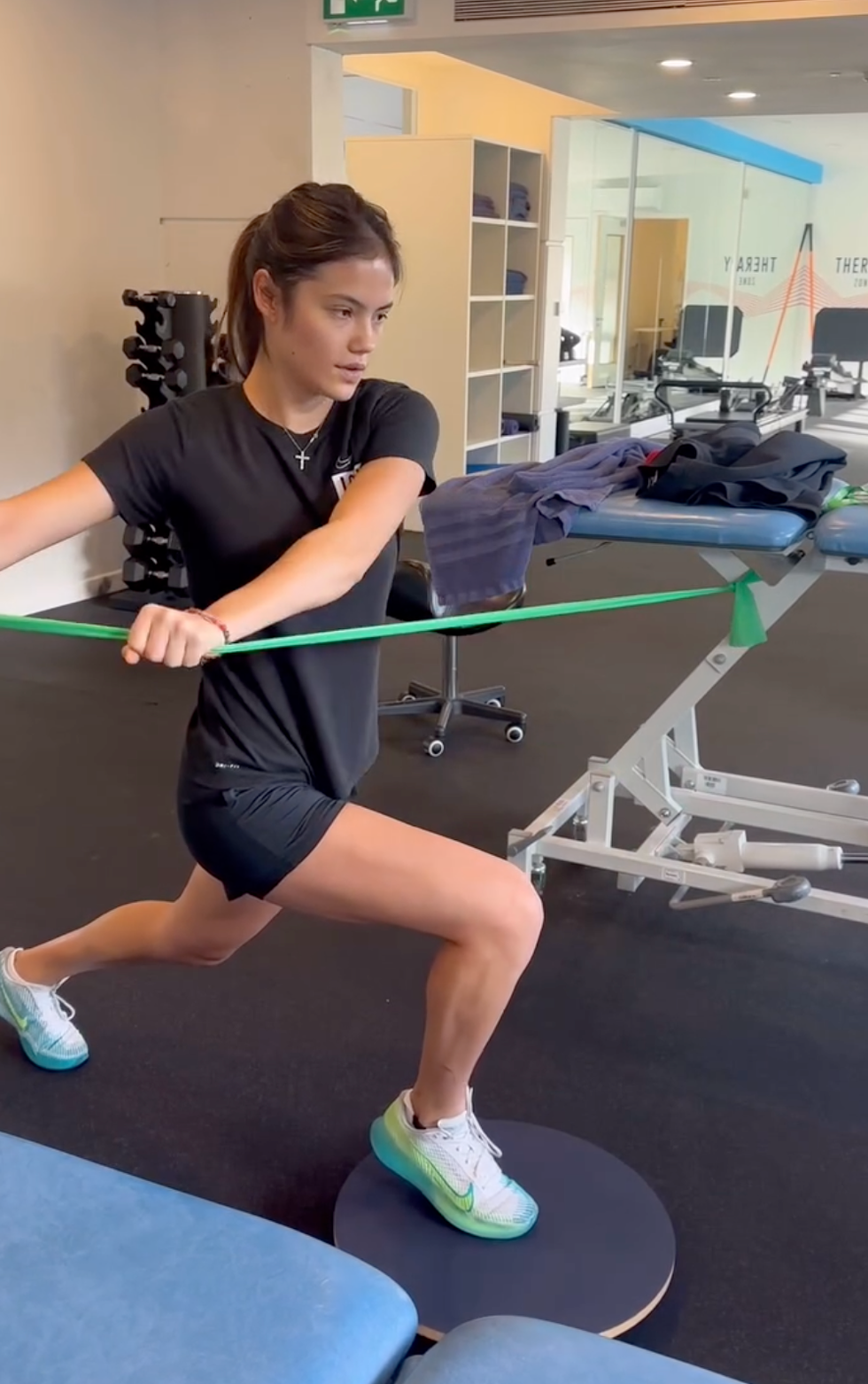 emma raducanu workout: emma performing a resistance band exercise in a gym