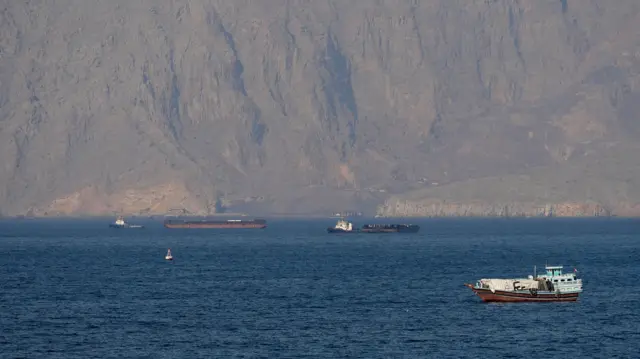 Ships and tankers remain stranded in the Strait of Hormuz off the coast of Musandam, Oman