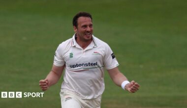Leicestershire bowler Josh Davey celebrating taking a wicket with his arms out wide, clenching his fists.