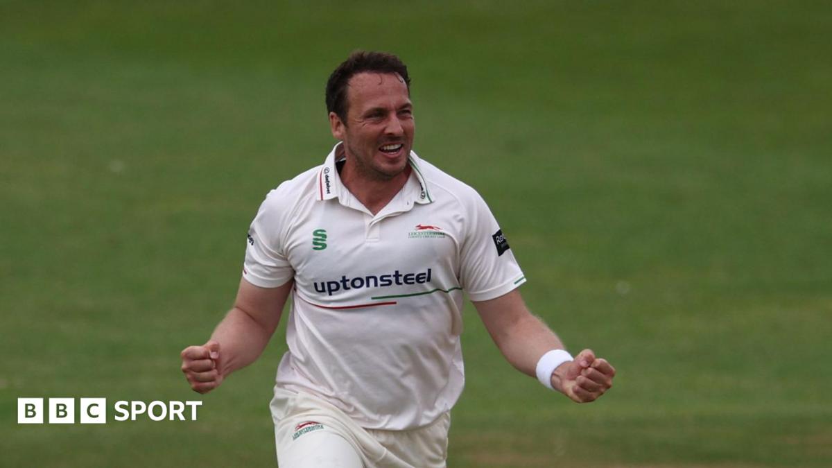 Leicestershire bowler Josh Davey celebrating taking a wicket with his arms out wide, clenching his fists.