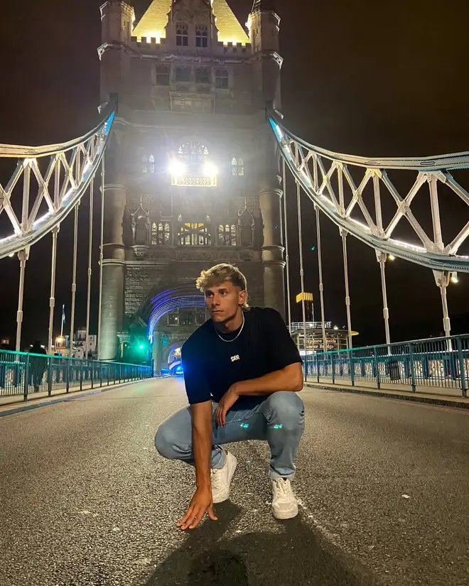Love Island's Sean picture posing on London Bridge.