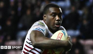 Sam Eseh playing for Wigan, carrying the rugby ball in his right arm