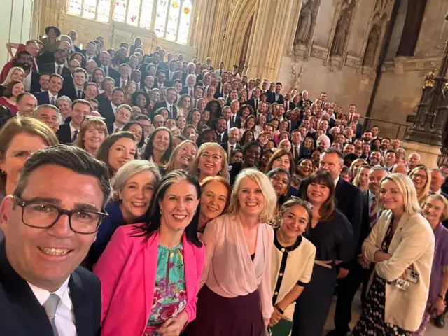 Andy Burnham takes a selfie with a large group of Labour MPs in Westminster Hall. He is smiling, as are the majority of Labour MPs, with the entire hall nearly filled