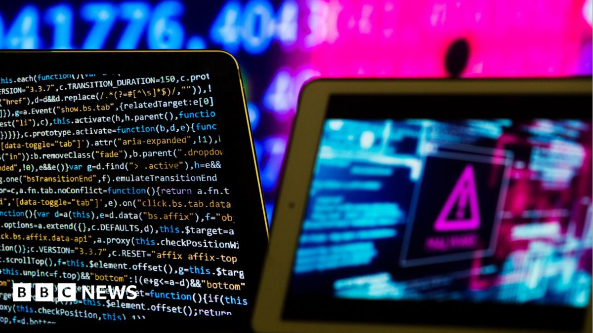 Composite image meant to represent computer software and hardware. On the left is a screen showing code in different colours. There is a pink hazard sign on the right of the picture.