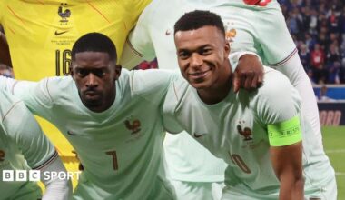 Ousmane Dembele and Kylian Mbappe pose in a pre-match team photo