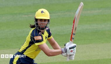 Maia Bouchier, in yellow and blue kit, plays a shot for Hampshire Hawks against Essex on 7 June