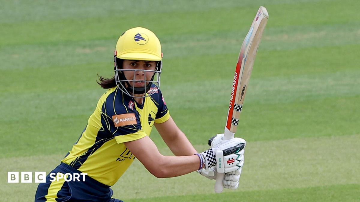 Maia Bouchier, in yellow and blue kit, plays a shot for Hampshire Hawks against Essex on 7 June