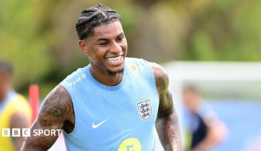 Marcus Rashford smiles during training