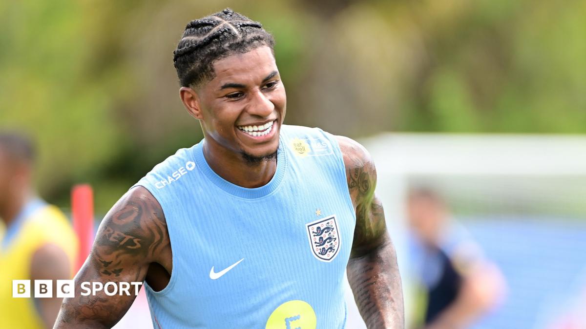 Marcus Rashford smiles during training