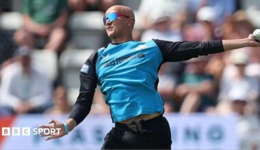 Fateh Singh is about to complete his bowling action in a white-ball game for Worcestershire. He is wearing black trousers and a top with black sleeves and light blue front. He is also wearing sunglasses