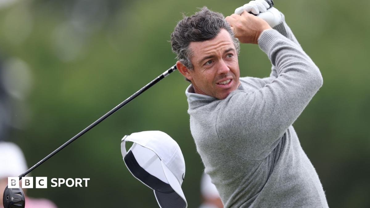 Rory McIlroy's cap flies off on the 13th hole