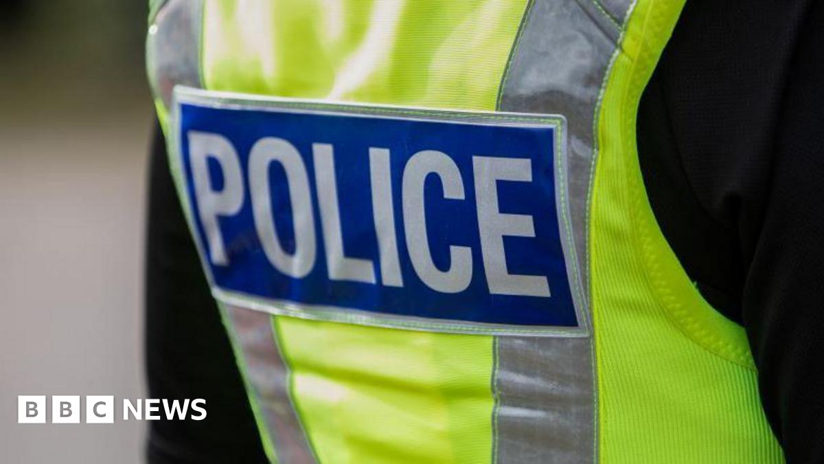 Police officer wearing a high vis jacket that says "police"