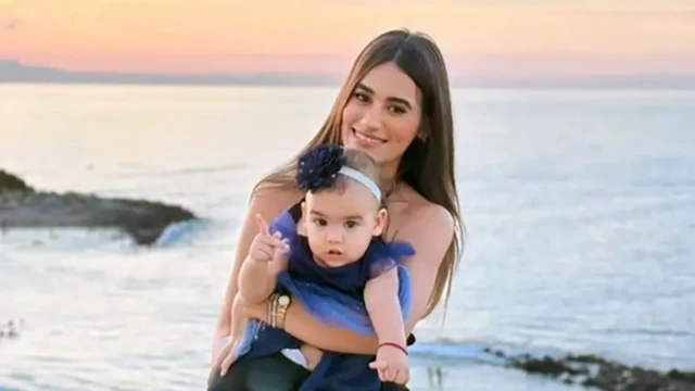 A woman holding a baby in her arms