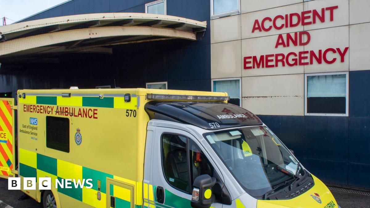 An ambulance parked outside Luton and Dunstable Hospital's Accident and Emergency department. The vehicle is yellow and green.