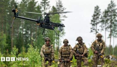British Army soldiers from 3 Rifles watch a single-rotor helicopter style Ghost drone on exercises in Finland