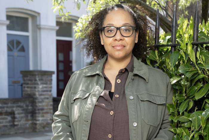Libby Fox Belinda Owusu as Libby Fox in EastEnders, wearing a green jacket and purple shirt.