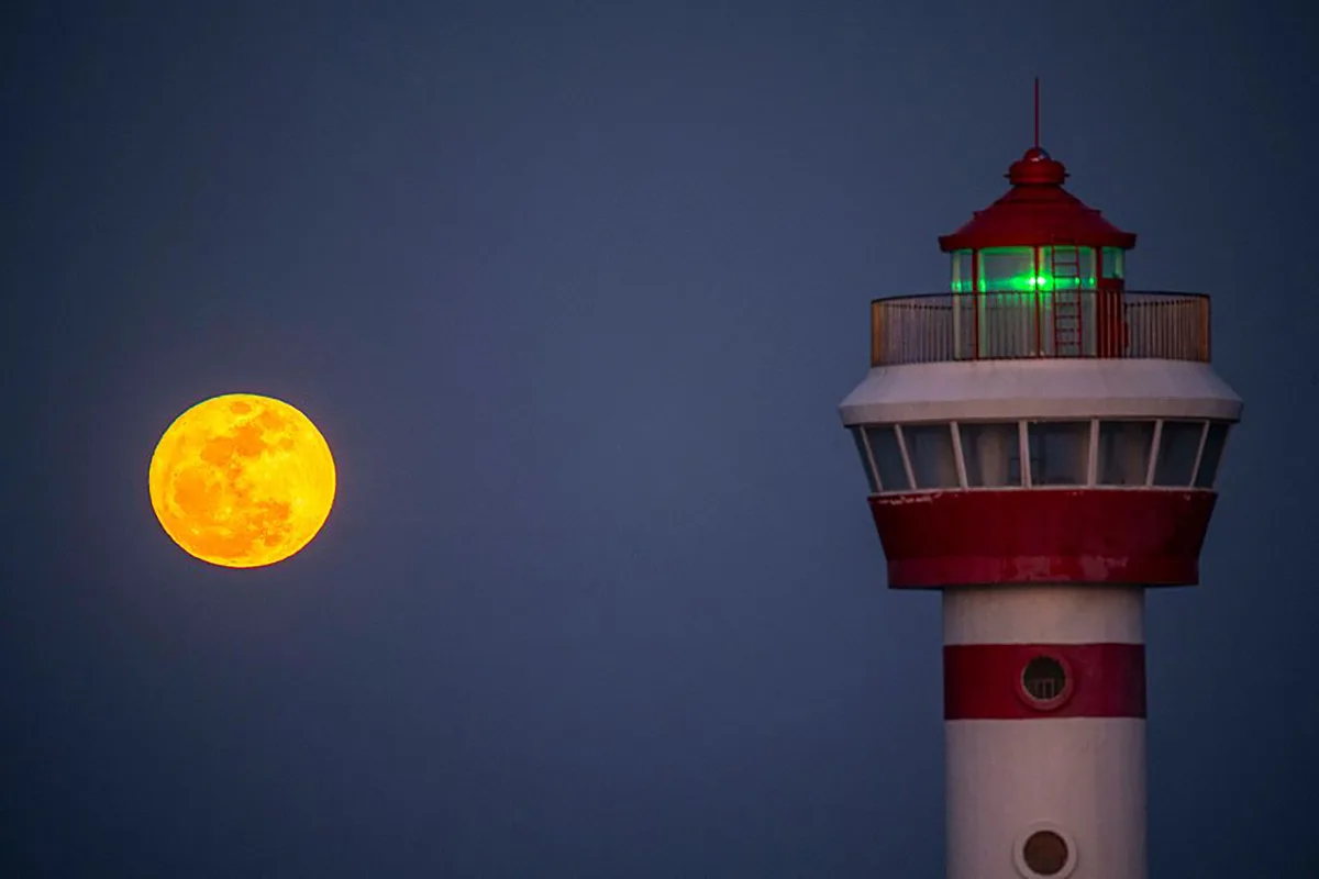 The Blue Moon over Tanmen Port in Qionghai, Hainan Province of China, 31 May 2026. Photo by Meng Zhongde/VCG via Getty Images. Lighthouse