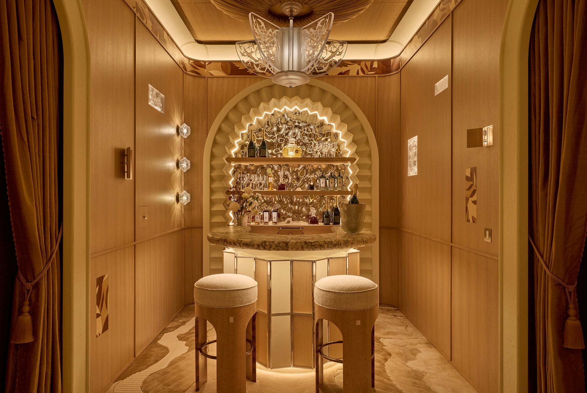 a small beautifully lit home bar in wowhouse 2026 with atmosphere lighting and two stools