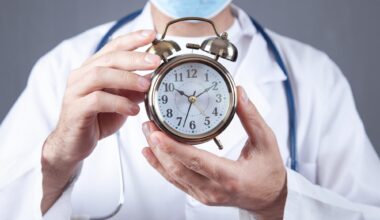 Doctor Holding Alarm Clock Longevity Aging