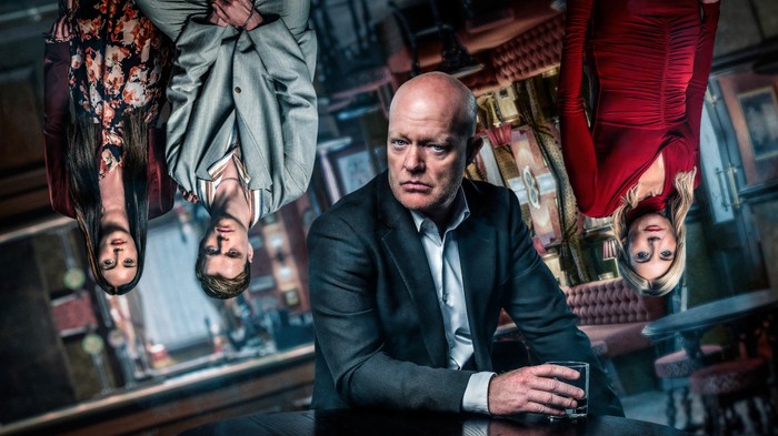 EastEnders - TNTCE_Max EastEnders - The Night That Changes Everything with Max Branning sat down and Lauren Beale, Oscar Branning and Cindy Beale standing up but stylised as upside down.