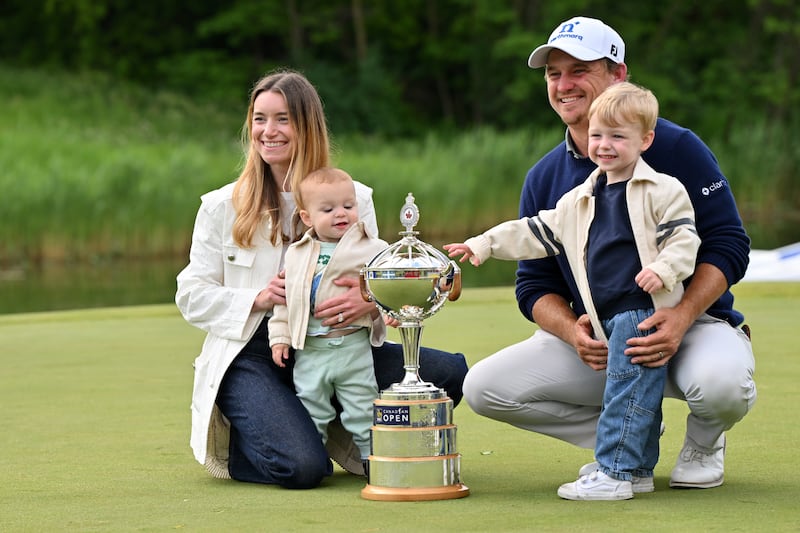 Bud Cauley with his wife Kristi and their two sons on the 18th hole after his win at the RBC Canadian Open at TPC Toronto. Photograph: Minas Panagiotakis/Getty Images