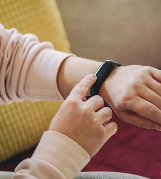 Woman examining her blood pressure with smart watch - stock photo