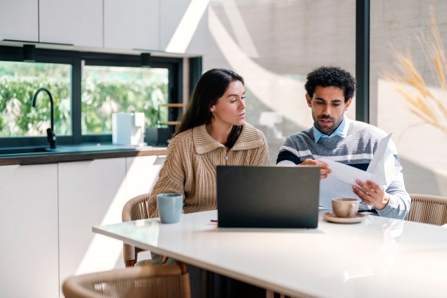 Young couple cooperating while going through their home finances.