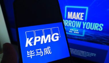 SUQIAN, CHINA - MAY 19, 2026 - A netizen is checking KPMG logo on his mobile phone and KPMG webpage on his computer in Suqian City, Jiangsu Province, China on May 19, 2026. (Photo credit should read CFOTO/Future Publishing via Getty Images)