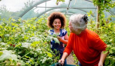A senior woman and young girl help out in the greenhouse at the local farm.