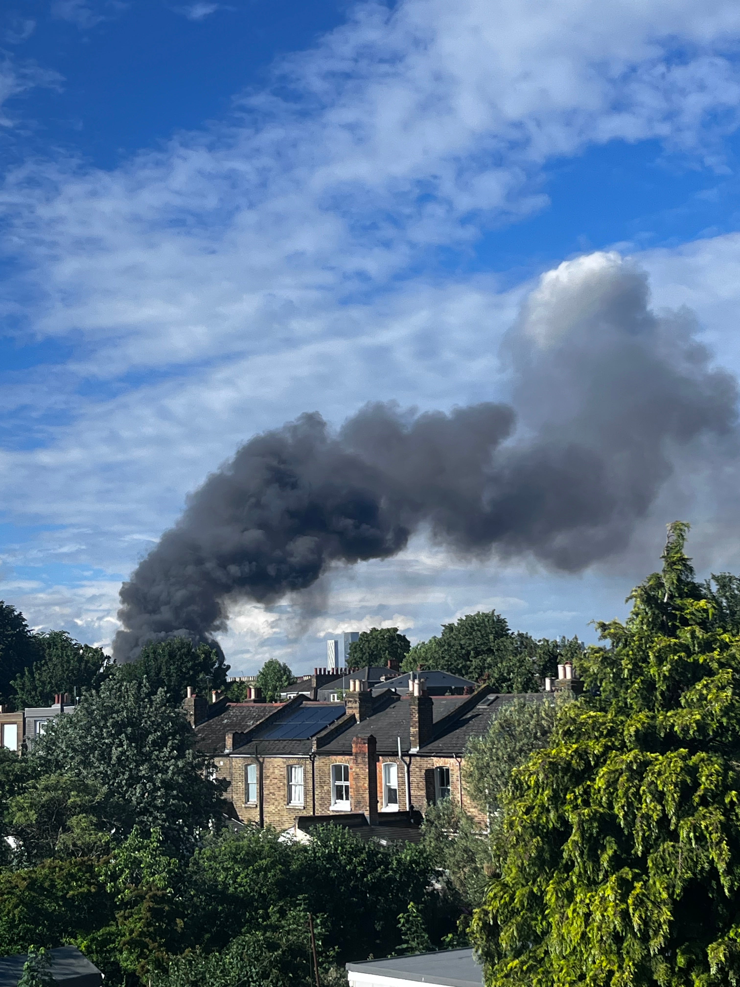 A column of smoke billows over southeast London on Monday afternoon amid a blaze at a recycling plant