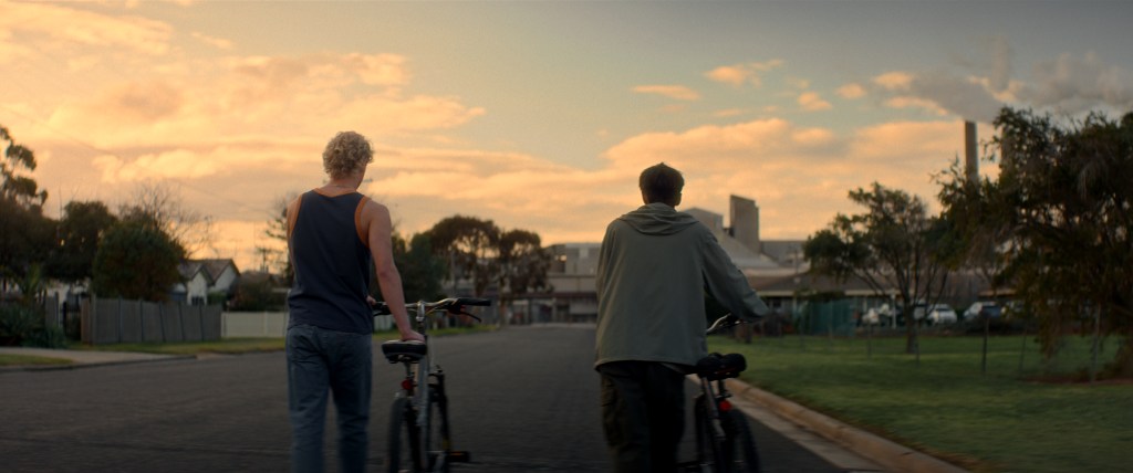 Leviticus still: two boys pushing bikes at sunset