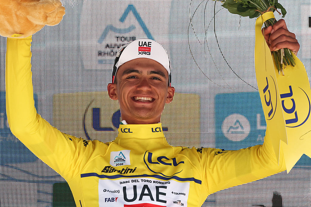 UAE Team Emirates XRG's Mexican rider Isaac Del Toro Romero celebrates with the overall leader's yellow jersey on the podium after winning the 8th and final stage of the Tour Auvergne-Rhone-Alpes cycling race (formerly known as the Criterium du Dauphine), 120,1km between Beaufort and Plateau de Solaison, in the French Alps on June 14, 2026. (Photo by Anne-Christine POUJOULAT / AFP)