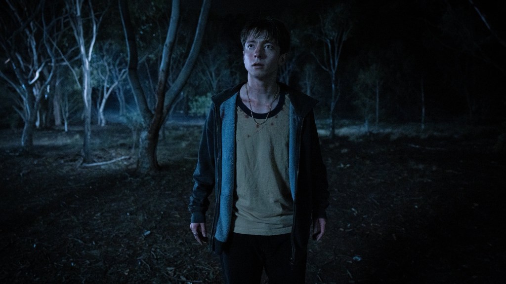 Leviticus still: nighttime, a boy in the dark looking scared