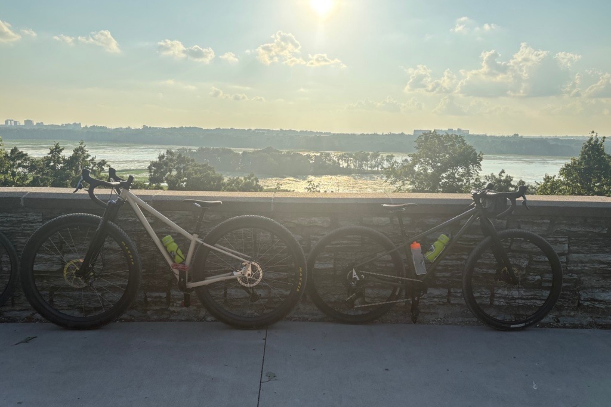 Two bikes leant against a wall
