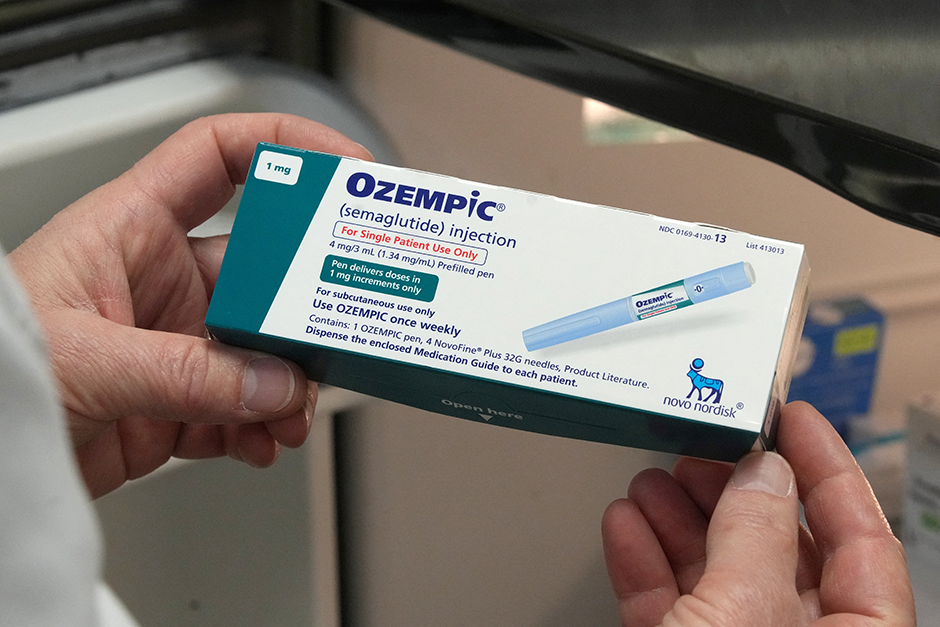 A pharmacist displaying a box of Ozempic, a semaglutide injection drug used for treating type 2 diabetes and made by Novo Nordisk. pharmaceutical ads