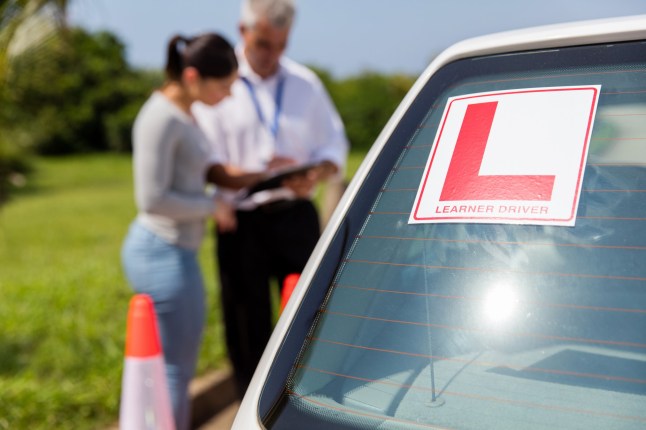 learner driver sign on a car with student and instructor standing behind; Shutterstock ID 364520768; Purchase Order: -