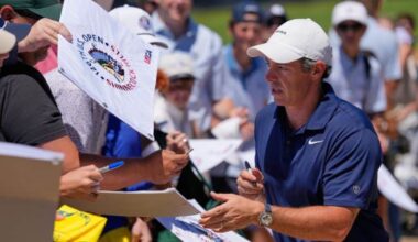 Rory McIlroy, of Northern Ireland, signs autographs during a practice round for the U.S. Open golf tournament at Shinnecock Hills Golf Club in Southampton, N.Y., Monday, June 15, 2026.(AP Photo/David J. Phillip)