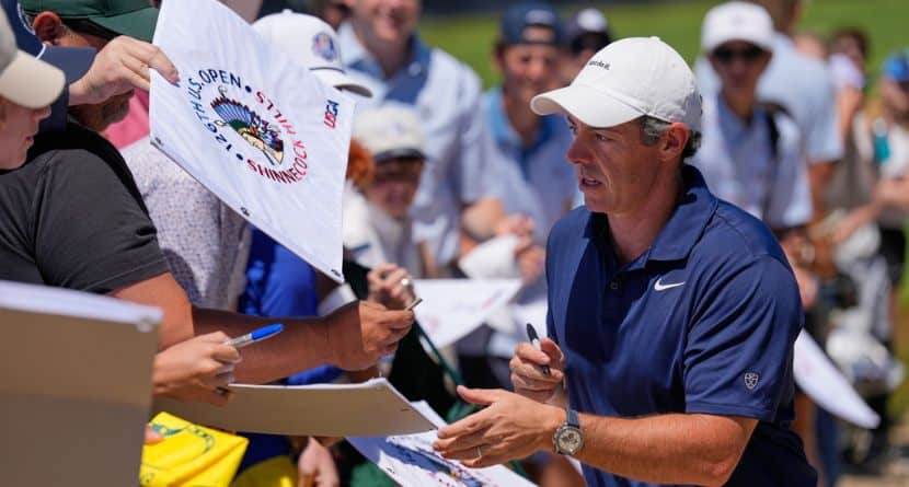 Rory McIlroy, of Northern Ireland, signs autographs during a practice round for the U.S. Open golf tournament at Shinnecock Hills Golf Club in Southampton, N.Y., Monday, June 15, 2026.(AP Photo/David J. Phillip)