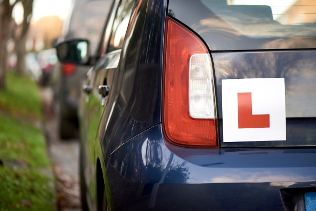 Laerner driver 'L' sign at the back of a blue hatchback compact car; Shutterstock ID 1411046801; purchase_order: -; job: -; client: -; other: -