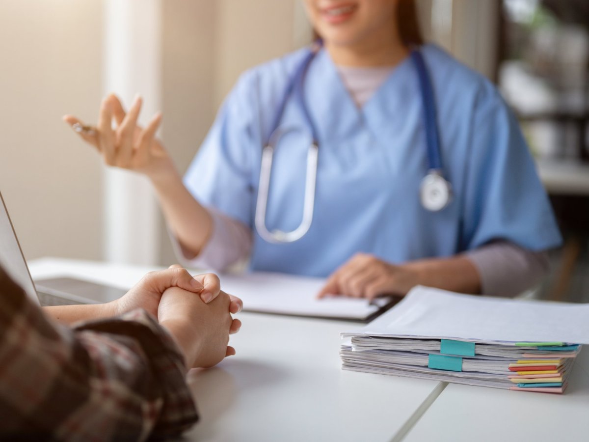 Close-up hand image of a serious patient having a medical consultation with a professional doctor at a hospital. Medical checkup, counseling, and diagnosis of disease