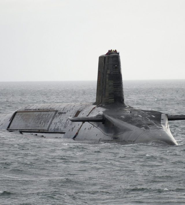 LARGS, SCOTLAND - FEBRUARY 27: In this handout image provided by MoD Crown Copyright, HMS Vengeance departs for Devonport prior to re-fit on Ferbruary 27, 2012 off the coast of Largs, Scotland. The UK Ministry of Defence has awarded UK's leading naval support business Babcock, on March 25, 2012, with a contract to commence the planning phase for the ??350 million GBP refit of Trident ballistic missile submarine HMS Vengeance, which will be undertaken at their Devonport Royal Dockyard. The project to upgrade and refuel the nuclear submarine will safeguard 2,000 UK jobs and will take around three and a half years. River Tamar shipping was suspended when the the 150m-long, 15,900-tonne submarine HMS Vengeance travelled to the Devonport Dockyard ahead of the scheduled refit on March 2, 2012, arriving amid concerns without a signed contract for the refit. HMS Vengeance will be the last of four Vanguard class submarines to undergo a Lond Overhaul Period and Refuel LOP(R) at Davernport that will commence once HMS Vigilant leaves Devonport on completion of her LOP(R) in 2012. Mandatory Credit: (Photo by Andrew Linnett/MoD Crown Copyright via Getty Images)