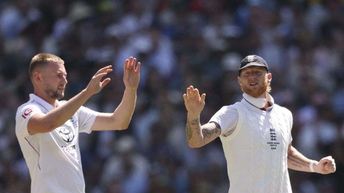 England's Gus Atkinson (L) celebrates the wicket of Australia's Scott Boland with Ben Stokes during the second day of the fourth Ashes cricket Test match between Australia and England at the Melbourne Cricket Ground (MCG) in Melbourne, Australia on December 27, 2025. (Photo by Martin KEEP / AFP via Getty Images) / -- IMAGE RESTRICTED TO EDITORIAL USE - STRICTLY NO COMMERCIAL USE --