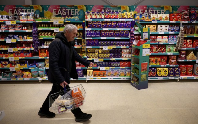A shopper walks past shelves displaying easter eggs and chocolates inside a Tesco supermarket in Manchester, Britain. (Pictures: Reuters)