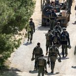 Israeli army soldiers gather on the border with Lebanon in the Upper Galilee, northern Israel on March 16, 2026. The Israeli military said on March 16 that it had begun what it described as 