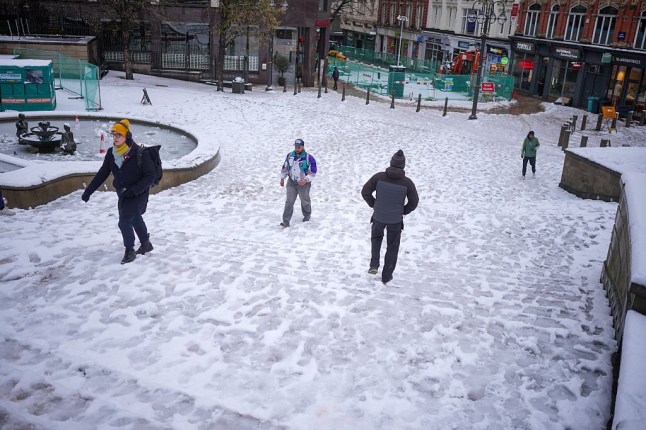 BIRMINGHAM, UNITED KINGDOM - JANUARY 09: People make their way through Victoria Square after overnight snow on January 09, 2026 in Birmingham, United Kingdom. Storm Goretti, named by M??t??o-France, is the first named storm of 2026 to hit the UK. Red 