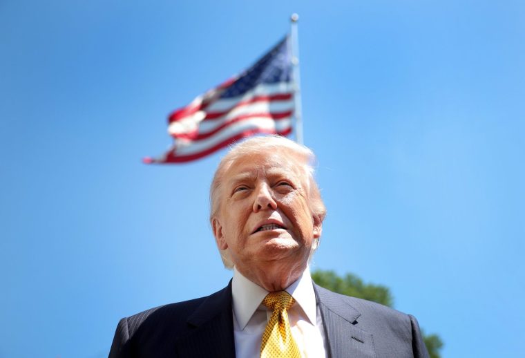 WASHINGTON, DC - MAY 12: U.S. President Donald Trump speaks in front of the American flag to the press as he departs the White House on May 12, 2026 in Washington, DC. Trump is traveling to China where he is scheduled to meet with Chinese President Xi Jinping for expected talks on the Iran conflict, trade imbalances, regional security, and economic cooperation between the two countries. (Photo by Kevin Dietsch/Getty Images)