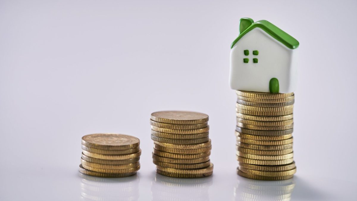 House Model on Top of Stack of Coins